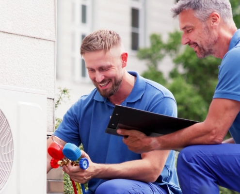 Professionals inspecting new HVAC unit