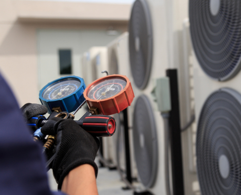 Technician is checking air conditioner ,measuring equipment for filling air conditioners