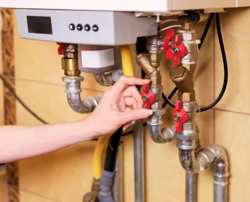 Person checking their gas furnace at home