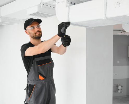hvac technician at work. ventilation, heating system maintenance and repair