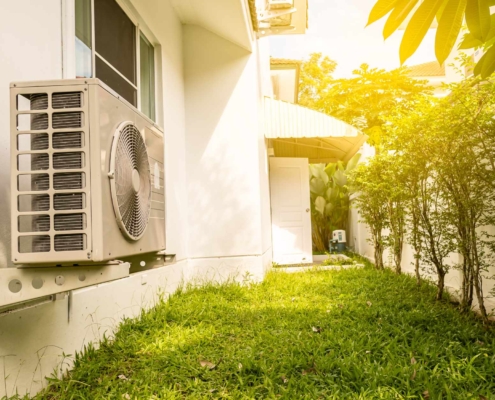 Residential HVAC unit outside on side of house